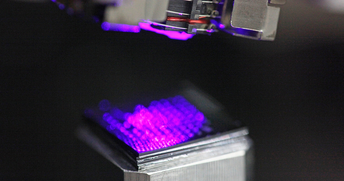 Xbox 360 optical pick up unit (upper part) shining a blue laser on a substrate for micro/nanoscale 3D printing (lower part). Photo by Jesper Scheel.