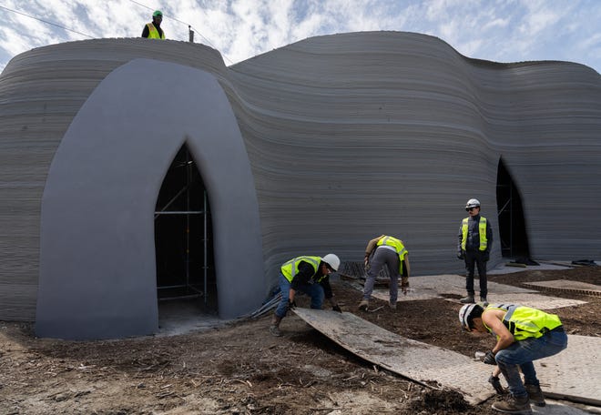 Workers complete construction Saturday of a 3D-printed building created by Icon in Austin.  The 27-foot-tall building was built to test a new printer called the Phoenix.